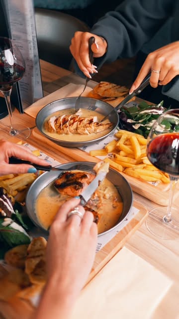 Guests sharing a generous Estábulo meal with fresh side salads