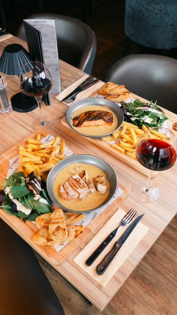 A generous plated meal with salad, chicken and warm bread